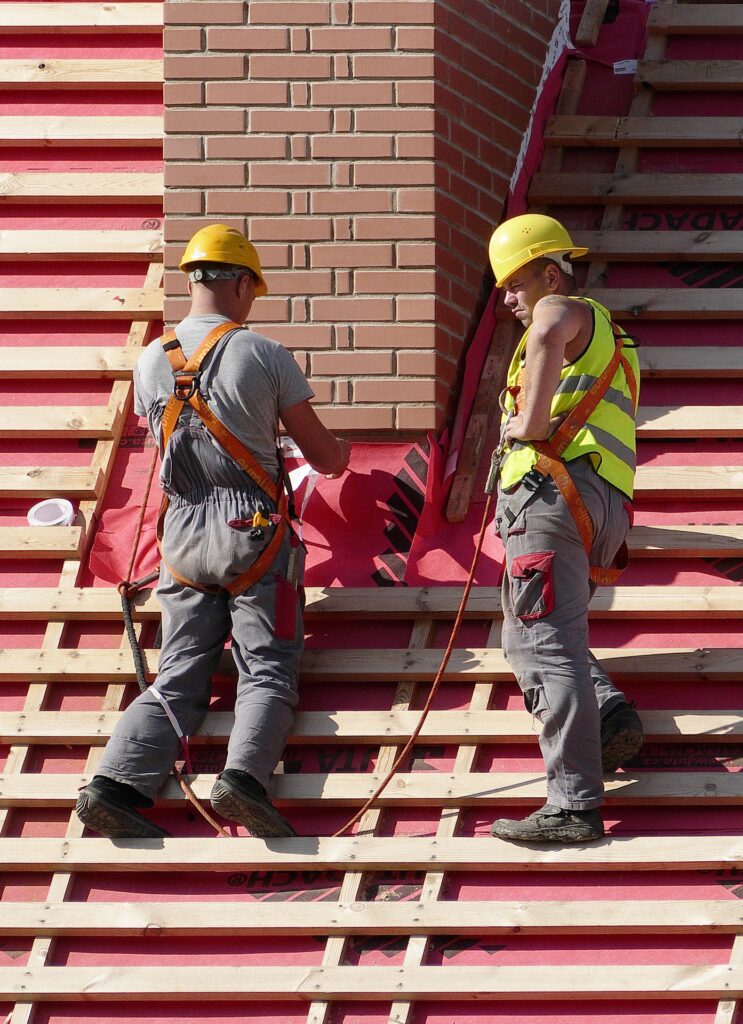 two men working on roof replacement