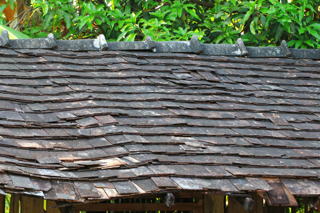 Old, sagging, and dilapidated asphalt roof in Florida